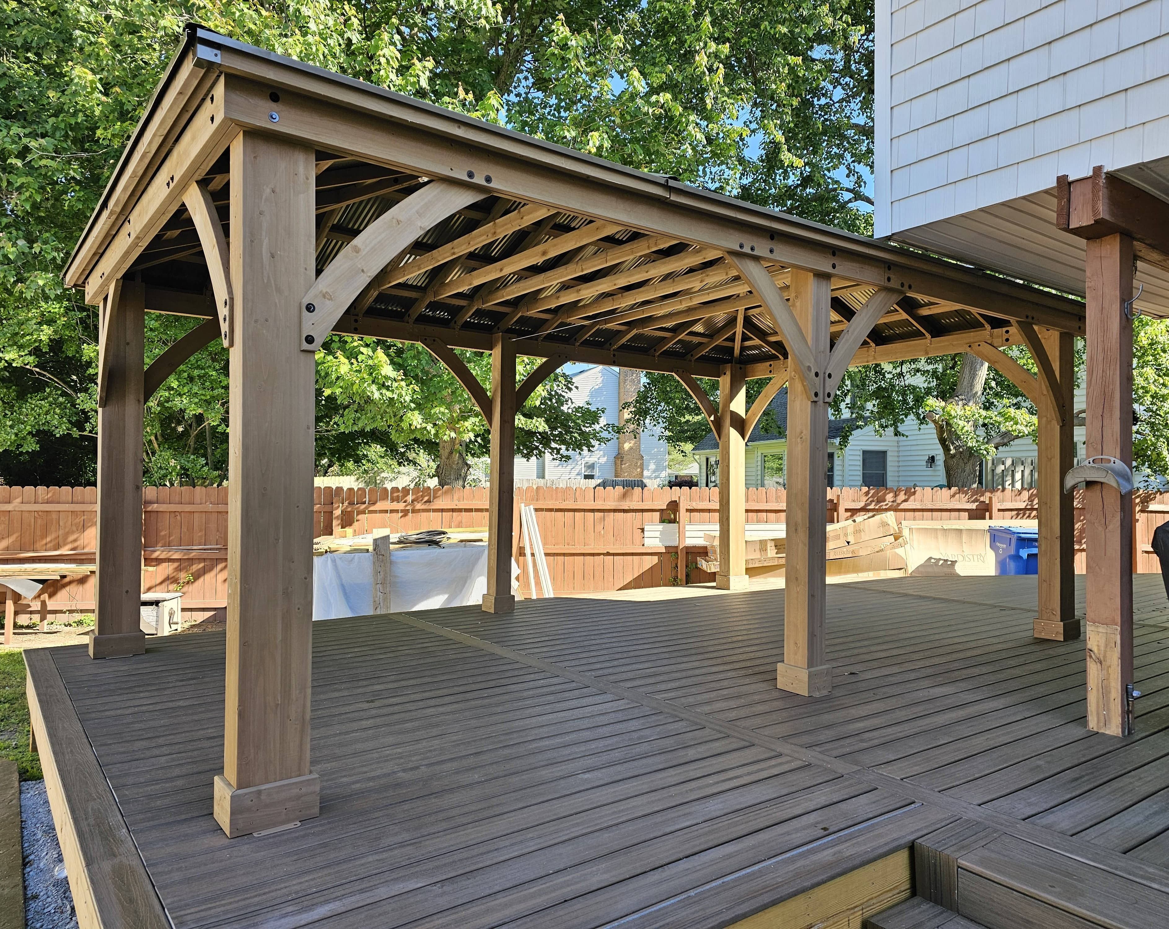 Completed wooden gazebo installation on a backyard deck