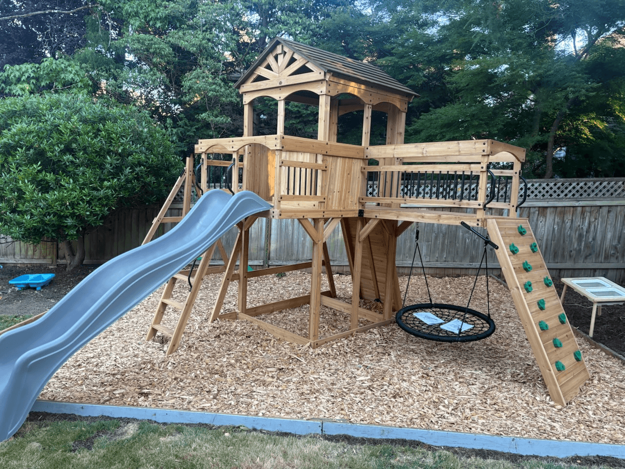 Completed wooden backyard playset assembly