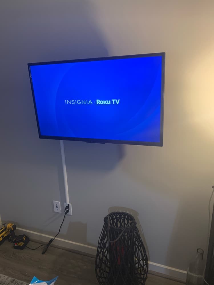Mounted television with an on-wall cable concealment channel