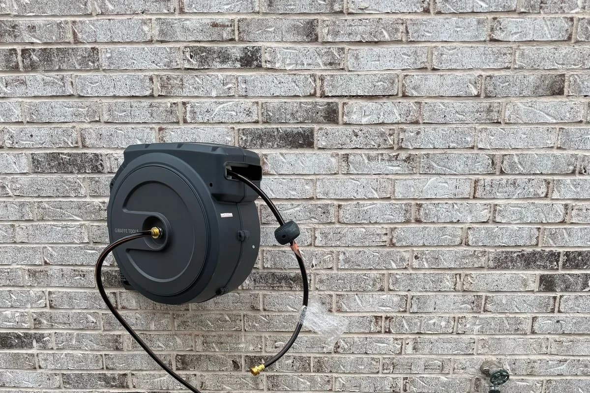 Exterior wall-mounted hose reel installation